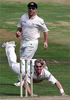 Australia's Brett Lee dives at the stumps to run out Mark Butcher.