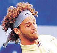 Gustavo Kuertin of Brazil returns a shot.