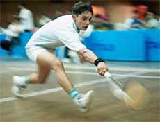 Naresh of Chandigarh stretches to return a shot from Varun.
