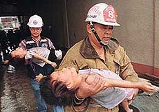 Filipino rescuers carry children injured in a pre-dawn hotel fire.