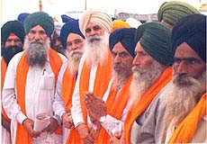 Bharti Kisan Union leaders Ajmer Singh Lakhowal and Manjit Singh Qadian while receiving 'siropas ' from Giani Bhagwan Singh, head granthi, Akal Takht, at Amritsar on Sunday.  