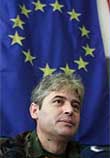 The reclusive leader of ethnic Albanian guerrillas in Macedonia, Ali Ahmeti (3rdL) waits for journalists' questions.