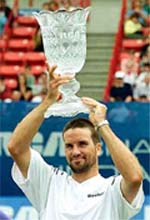 Patrick Rafter of Australia holds the trophy after winning the RCA Championships.