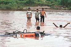 A partially visible truck which was spotted on the Ghaggar riverbed near Bhankharpur village, along the Chandigarh-Ambala highway, after being washed away by the strong water current up to a distance of 1 km downstream during the recent floods. 