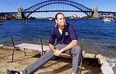 Vangipurappu Laxman sits infront of the Sydney Harbour Bridge and Opera House on Tuesday after undergoing knee surgery last week.