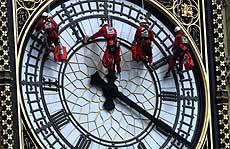 A team of glaziers cleans and repairs one of the faces on the clock tower of the Palace of Westminster in London on Monday.