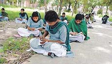 Students of Government Senior Secondary School, Bharat Nagar, attend classes in the open because of shortage of classrooms. 