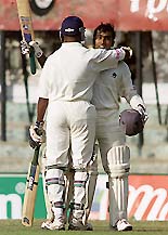 Sri Lankan batsman Chaminda Vas (L) hugs his team mate Mahela Jayawardene after the latter reached his century during the first day of the second Test against India in Kandy, on Wednesday.