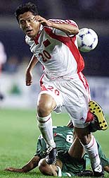 China's Yang Chen (F) and the UAE's Jaleel Abdulrahman Mohamed Hosani fight for the ball during their World Cup soccer qualifying match in Shenyang.