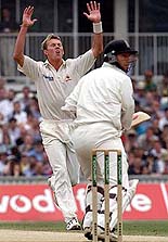 Australia's bowler Brett Lee (L) shows his frustration as England's opener Mike Atherton (R) looks back on the fourth day of the final Ashes Test at The Oval in London on Sunday. 