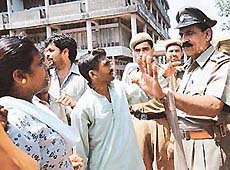 A police official tries to pacify agitating members of the Footpath Cycle Workers Union outside the DC Office, Sector 17, Chandigarh, on Monday.