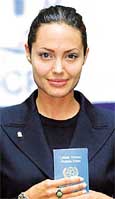 Angelina Jolie holds her UN passport 