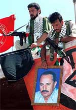 Palestinian members of the Popular Front for the Liberation of Palestine hang black flags.