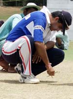 Indian captain Saurav Ganguly uses scissors to examine the hardness of the pitch at the Sinhalese Sports Club grounds in Colombo on Tuesday.