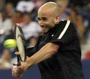Andre Agassi of the USA hits a backhand return to Mike Bryan of the USA during the first set of their first round match at the U S Open Tennis Championship in New York on Monday.
