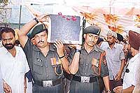 Army personnel, carrying the body of Sub Paramjit Singh.