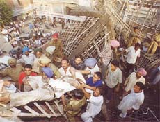 The body of Behari Lal Mangla being taken out of the debris in Bathinda on Wednesday.