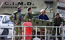 Australian troops unload a box from their inflatable boat 