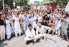 tudents raise slogans at a rally against a reported move to increase the pass percentage i