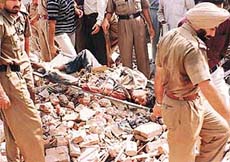 The police takes out a labourer from the debris of a collapsed building in the Janakpuri area on Thursday. Photo Rajesh Bhambi