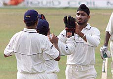 Indian bowler Harbhajan Singh (R) celebrates the dismissal of Sri Lankan batsman Marvan Atapattu with teammates on the second day of the third and final cricket test in Colombo on Thursday.