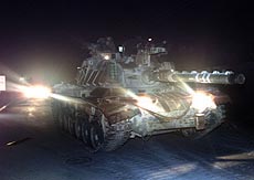 An Israeli tank leaves the West Bank town of Beit Jala on its way to the Jewish settlement of Har Gilo early morning of Thursday. 
