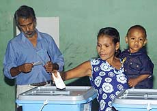 East Timor's independence leader Xanana Gusmao (left) checks his ballot as he waits to vote in Manatuto, 40 km east of the capital, Dili, in the country's first democratic elections on Thursday. 