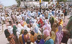 Residents of Parasram Nagar hold a rally and block traffic at the main chowk to protest against the shifting of the PSEB office from there to an other place in Bathinda on Friday.