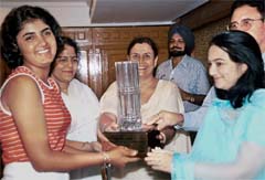 Irina Brar (left) is all smiles as she accepts the trophy presented by the Punjab Golf Association.