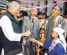 Finance Minister Yashwant Sinha (left) receives flowers from a schoolgirl