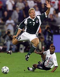Germany's Marko Rehmer (C) jumps over England's Ashley Cole