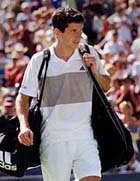 Britain's Tim Henman leaves the court after his loss to Xavier Malisse