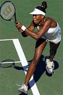 Defending women's' champion Venus Williams, of the USA, returns to Lisa Raymond, of the USA