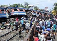 Local residents look at Indonesian trains that collided in the Indonesian port city of Cirebon on the main island of Java on Sunday.