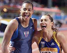 Marion Jones from the USA (L) laughs with current world champion Zhanna Pintusevich 
