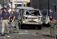 An Israeli policeman searches the scene where a suicide bomber blew himself up in the centre of Jerusalem 