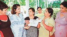 Ms Urmil Seth (third from left) shows the state award for teachers, which she returned to the Chandigarh Administration, to a councillor of the Municipal Corporation, Ms Satinder Dhawan, in Chandigarh on Wednesday.