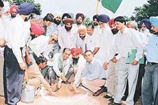 Dr B.M. Mahajan, Managing Director, Milkfed, Punjab, plants a sapling at a tree-plantation ceremony on the premises of the milk plant at SAS Nagar on Wednesday.