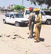 Policemen stand guard at the spot where the man was shot dead in Ludhiana on Thrusday. The bricks encircle a pool of the deceaseds blood.