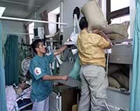 Workers put sandbags into the windows of the Intensive Care Unit in a hospital in the West Bank city of Hebron on Thursday.
