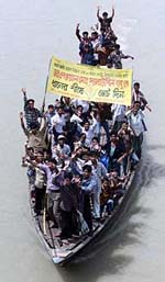 Supporters of the Bangladesh Nationalist Party (BNP) carry a banner with a call to "vote for sheaf of paddy" to an election rally at Savar near Dhaka on Thursday.