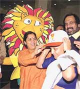 Union Minister for youth affairs and sports, Uma Bharati offering Afro-Asian games cap to Delhi Chief Minister Sheila Dixit 