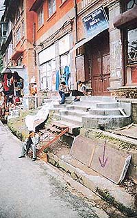 The Lakkar Bazaar road has sunk to such an extent that shopkeepers have to use iron steps to reach their establishments  