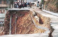 The road near the State Assembly on The Mall has caved in due to erratic digging for constructions on the Cart Road below