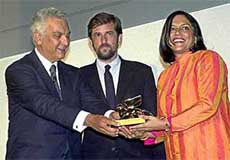 President of the Biennale Paolo Baratta hands the Golden Lion for the best film to Indian director Mira Nair 