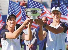 Top-seeded Rennae Stubbs of Australia (right) and Lisa Raymond of the USA hold up their trophy after winning their second womens doubles Grand Slam title of the year beating Nathalie Tauziat of France and Kimberly Po-Messerli 6-2, 5-7, 7-5 at the US Open on Sunday.
