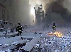 Firemen work around the World Trade Center after both towers collapsed in New York on Tuesday.