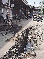 The 5-foot-deep pit half-filled with water under the Dholewal flyover, near the Division No. 6 police station. 