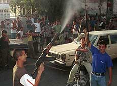 Two Palestinians fire in the air