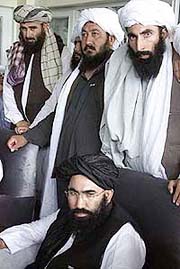 Taliban stand behind Mullah Abdul Salam Zaeef, Afghan Ambassador to Pakistan, during a news conference on Saturday in Islamabad, Pakistan. 